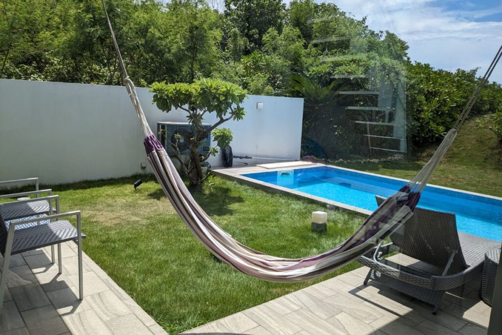 Relaxing view from a hammock at a private villa with a garden pool on Miyako Island, Okinawa.