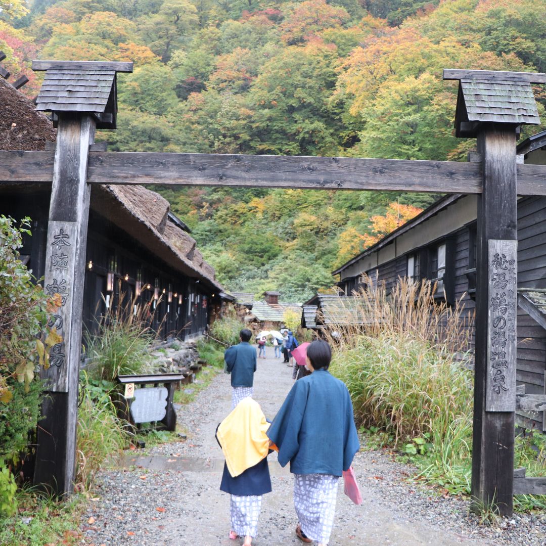 Family visiting a traditional ryokan with autumn leaves — top picks for family friendly onsen in Japan from our japan onsen guide.