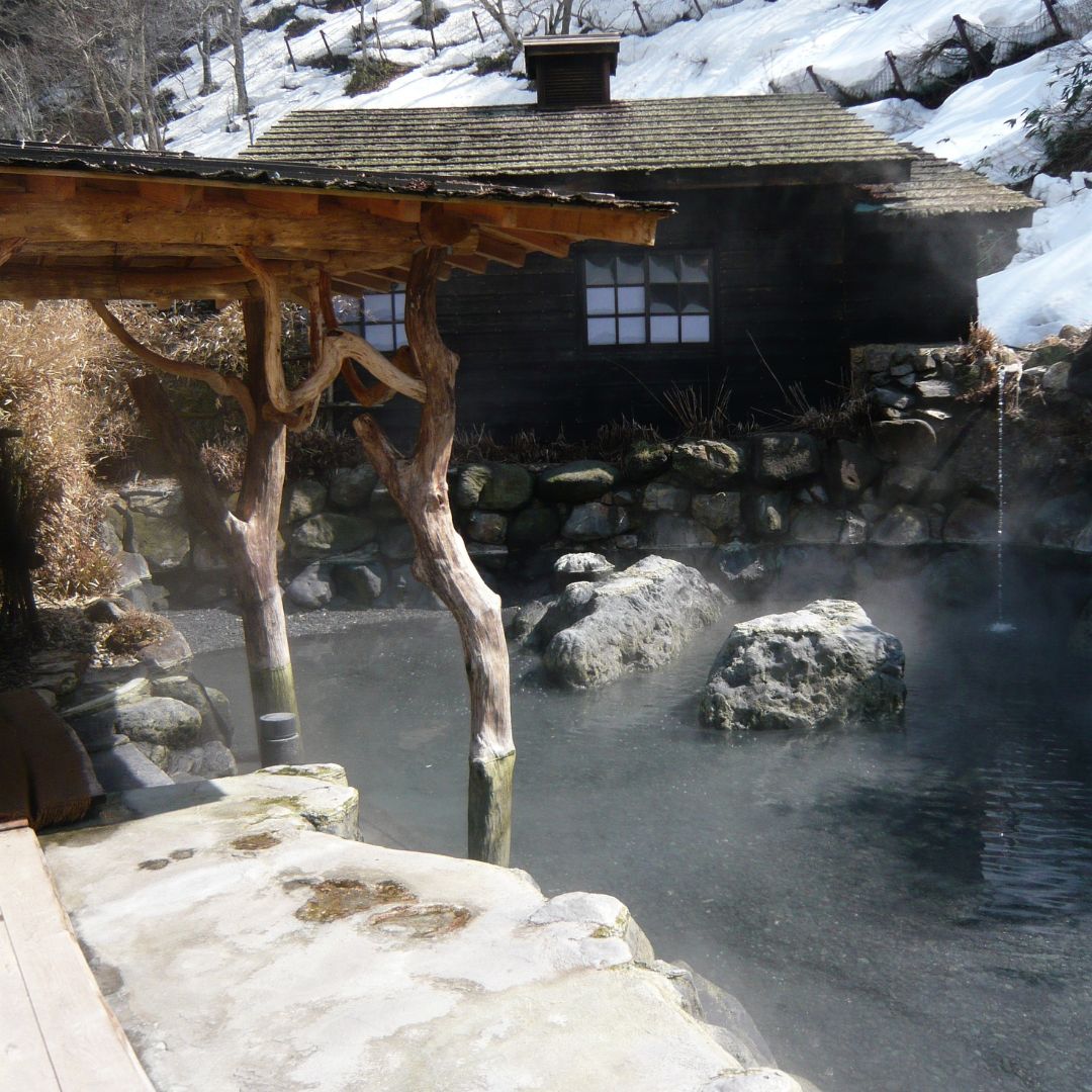 Snowy outdoor onsen bath surrounded by forest at Nyuto Onsen — a top pick for family friendly onsen japan.