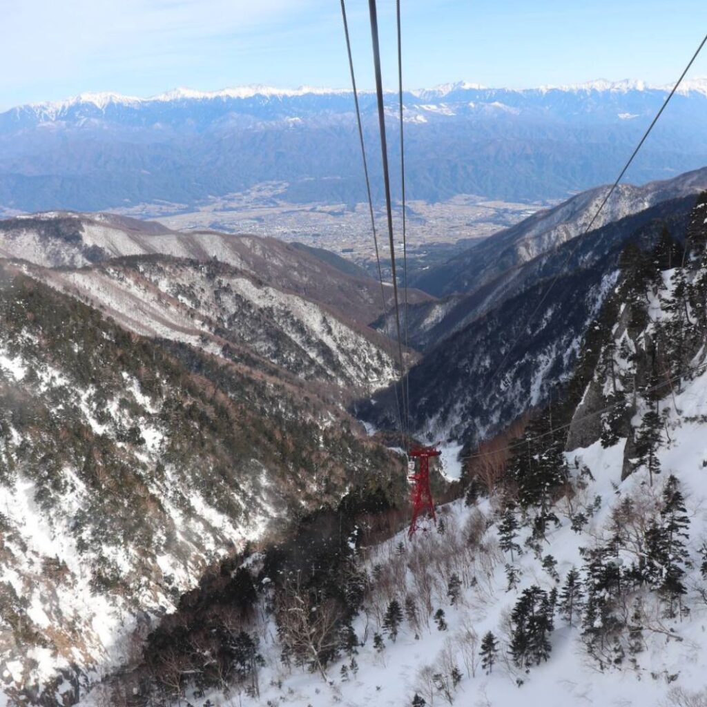 Komagatake Ropeway Japan gliding through green forest toward Senjojiki Curl – a family friendly hike Japan experience.