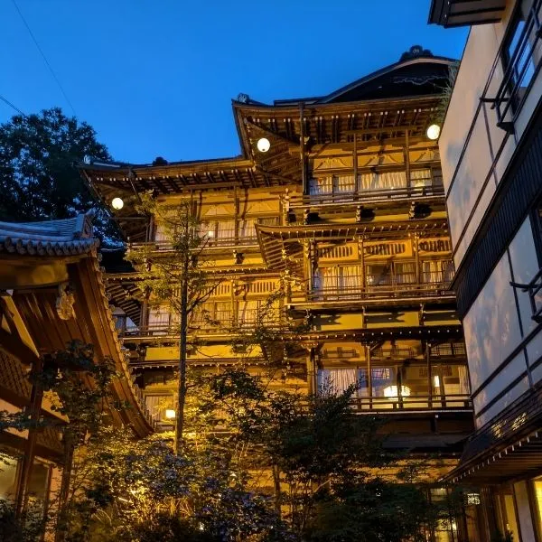 Exterior of the historic Kanaguya inn, lit up beautifully at night, said to inspire Spirited Away.