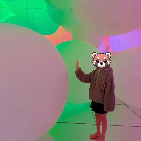 Tokyo Disneyland Tips – family side trip to teamLab Planets Tokyo, child interacting with glowing balls in immersive art installation.
