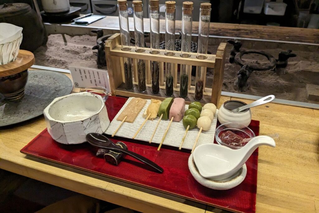 Colorful dango skewers and tea leaf test tubes at Nanakorobiyaoki near Fushimiinari Shrine in Kyoto