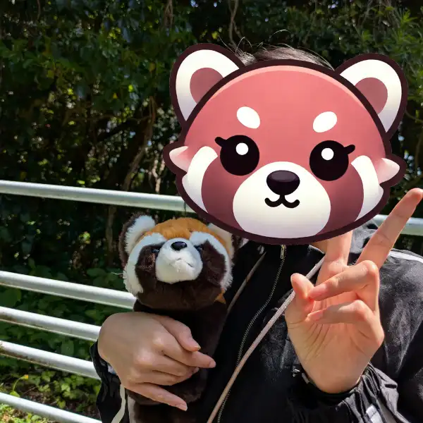 Our daughter holding her favorite red panda plush during a Japan family trip