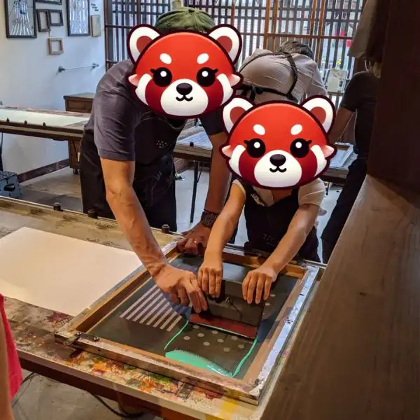 Child enjoying traditional tenugui dyeing in Gujo Hachiman — a fun hands-on activity during your family trip to Japan.