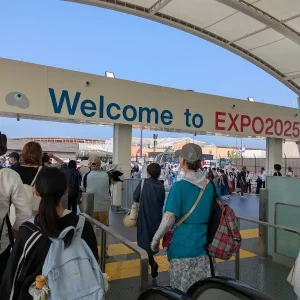 Welcome gate to Expo 2025 Osaka with crowds entering from the East Gate — start of our family adventure.