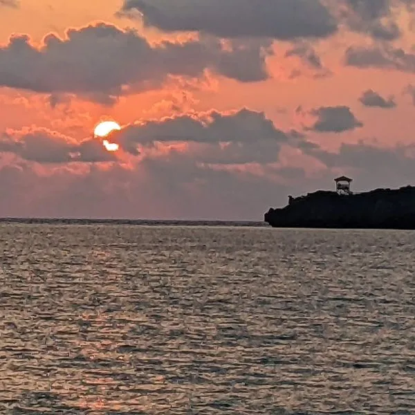 Relax and enjoy a spectacular sunset over the ocean from the private beach at Hoshino Resort Iriomote.