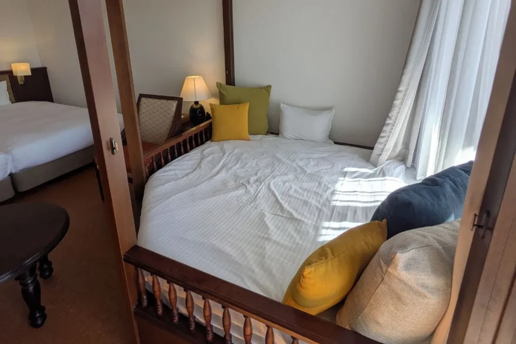 Cozy daybed corner in Iriomote Hotel room with natural light and colorful cushions