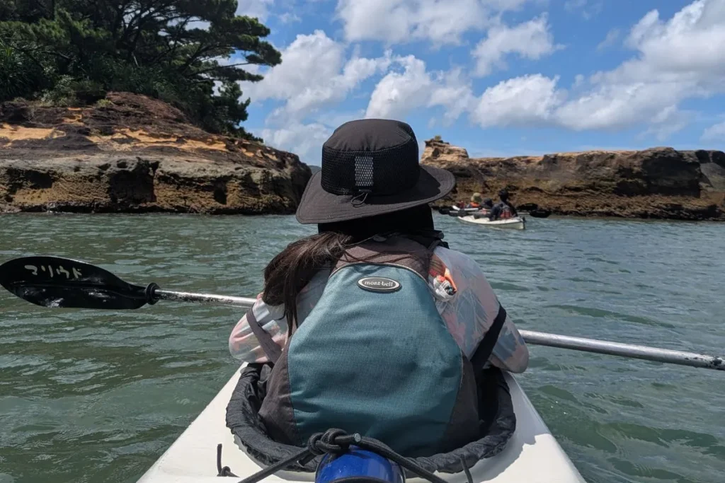 Paddling toward the sea caves of Iriomote, part of our family-friendly kayaking adventure.