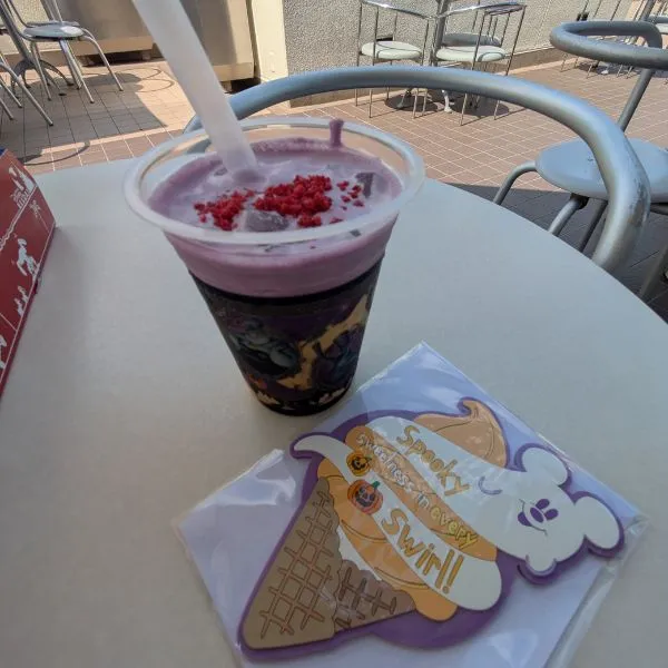 Tokyo Disneyland Halloween special drink with coffee jelly, pumpkin milk, and berry topping, a seasonal treat.