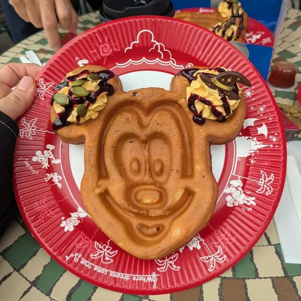 Mickey-shaped waffle cone with pumpkin toppings and whipped cream, served at Great Waffle Cone in Tokyo Disneyland.