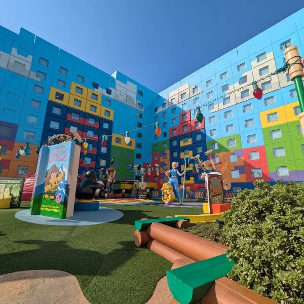 Colorful Toy Story Hotel outdoor play courtyard featuring Woody and Bo Peep statues.