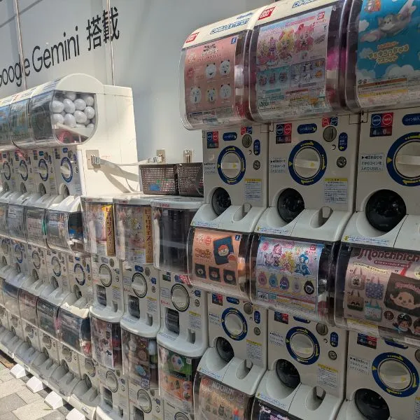 Akihabara street lined with capsule toy machines filled with anime merchandise.