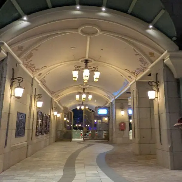 Night view of the elegant archway entrance connecting Toy Story Hotel Tokyo guests to DisneySea through the Fantasy Springs side gate.