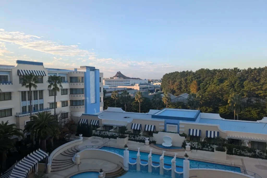 View of Disney Ambassador Hotel pool and DisneySea volcano from Minnie Mouse room at Tokyo Disney hotels for families