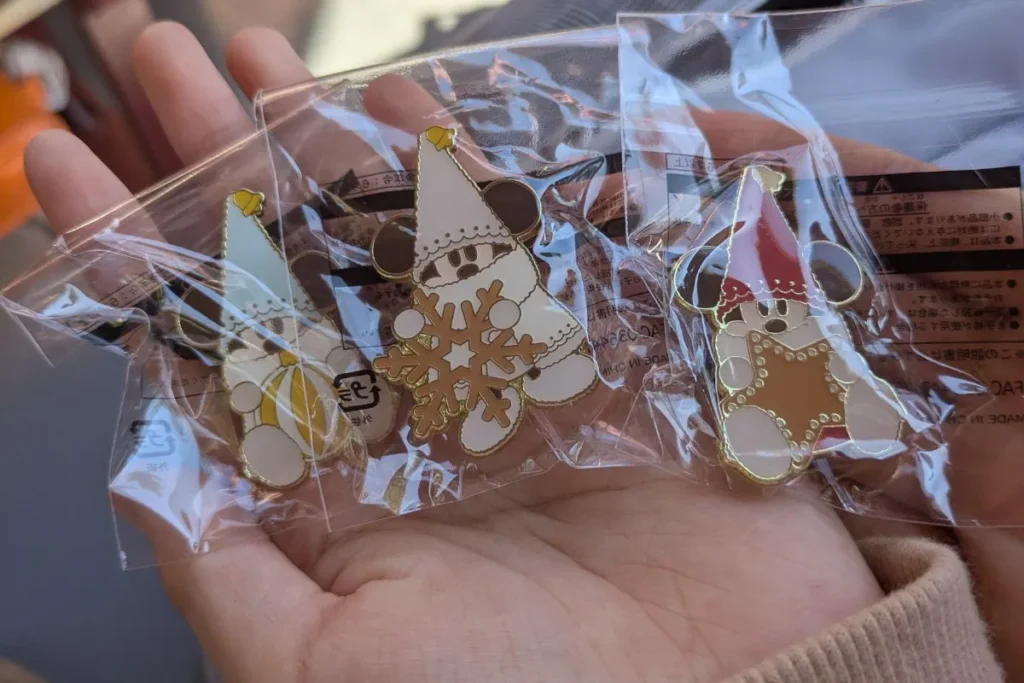 Lil’LinLin Christmas game consolation pin prizes collected on our Tokyo Disney Christmas itinerary